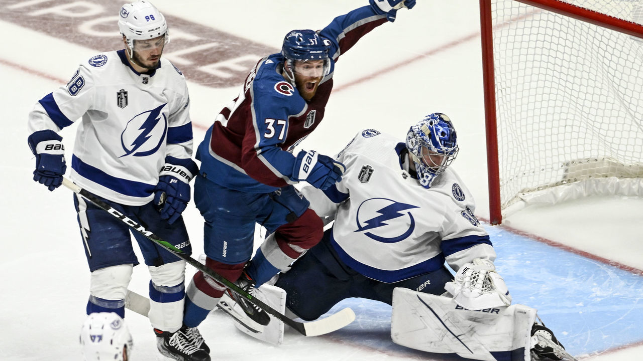 DENVER, CO - JUNE 15: J.T. Compher (37) of the Colorado Avalanche celebrates much to the chagrin of Mikhail Sergachev (98) and Andrei Vasilevskiy (88) of the Tampa Bay Lightning after Andre Burakovsky (95) scored a game winner during overtime of Colorado"u2019s 4-3 win in game one of the Stanley Cup Finals at Ball Arena in Denver on Wednesday, June 15, 2022.
