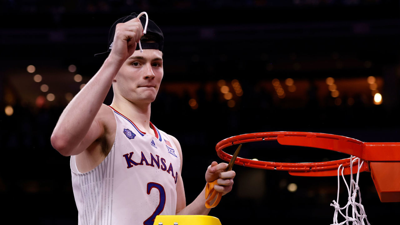 NEW ORLEANS, LA - APRIL 04: Christian Braun #2 of the Kansas Jayhawks cuts the net following their victory against the North Carolina Tar Heels during the 2022 NCAA Men's Basketball Tournament Final Four Championship at Caesars Superdome on April 4, 2022 in New Orleans, Louisiana.