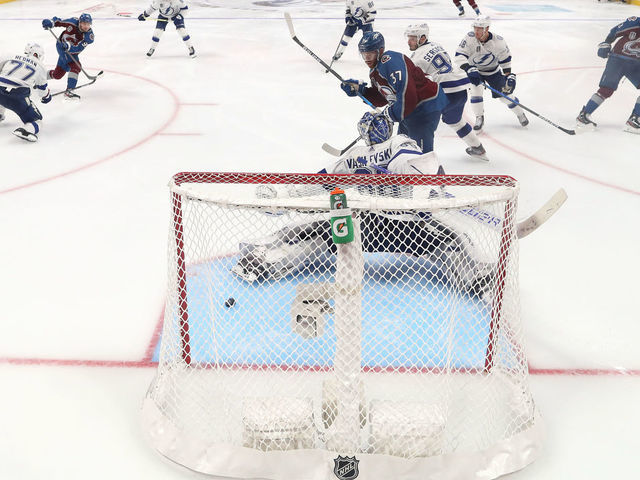 DENVER, COLORADO - JUNE 15: Andre Burakovsky #95 of the Colorado Avalanche scores a goal against Andrei Vasilevskiy #88 of the Tampa Bay Lightning during overtime to win Game One of the 2022 Stanley Cup Final 4-3 at Ball Arena on June 15, 2022 in Denver, Colorado.