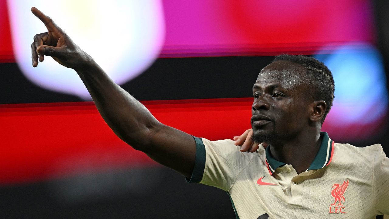 Liverpool's Senegalese striker Sadio Mane celebrates scoring the team's second goal during the English Premier League football match between Aston Villa and Liverpool at Villa Park in Birmingham, central England on May 10, 2022. - RESTRICTED TO EDITORIAL USE. No use with unauthorized audio, video, data, fixture lists, club/league logos or 'live' services. Online in-match use limited to 120 images. An additional 40 images may be used in extra time. No video emulation. Social media in-match use limited to 120 images. An additional 40 images may be used in extra time. No use in betting publications, games or single club/league/player publications.