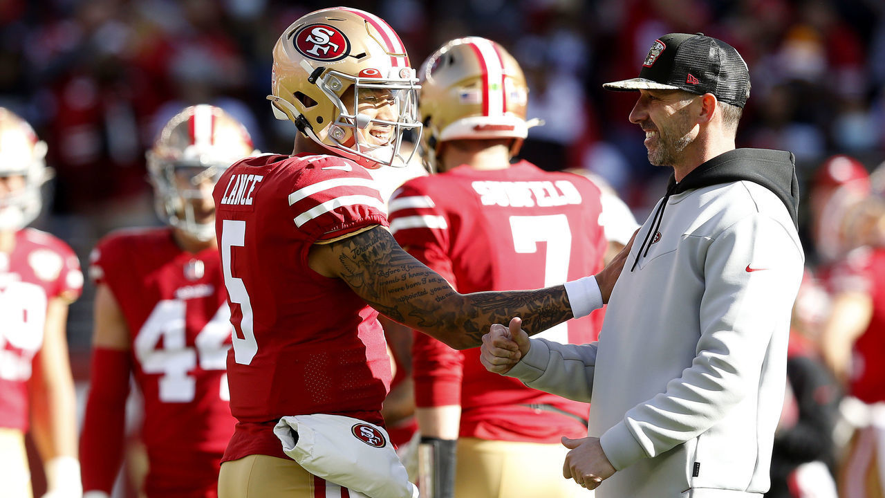 SANTA CLARA, CALIFORNIA - JANUARY 02: Trey Lance #5 of the San Francisco 49ers and Head Coach Kyle Shanahan of the San Francisco 49ers talk before the game against the Houston Texans at Levi's Stadium on January 02, 2022 in Santa Clara, California.