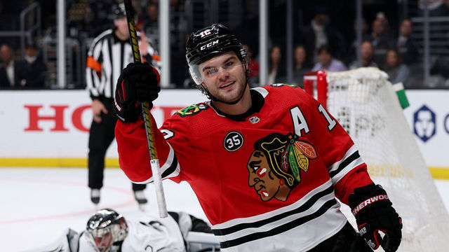 LOS ANGELES, CALIFORNIA - MARCH 24: Alex DeBrincat #12 of the Chicago Blackhawks celebrates his goal past Jonathan Quick #32 of the Los Angeles Kings, to clinch a 4-3 win in an overtime shootout at Crypto.com Arena on March 24, 2022 in Los Angeles, California.