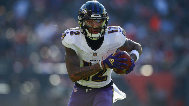 CHICAGO, IL - NOVEMBER 21: Baltimore Ravens wide receiver Rashod Bateman (12) runs with the ball during a NFL game between the Baltimore Ravens and the Chicago Bears on November 21, 2021 at Soldier Field in Chicago, IL.
