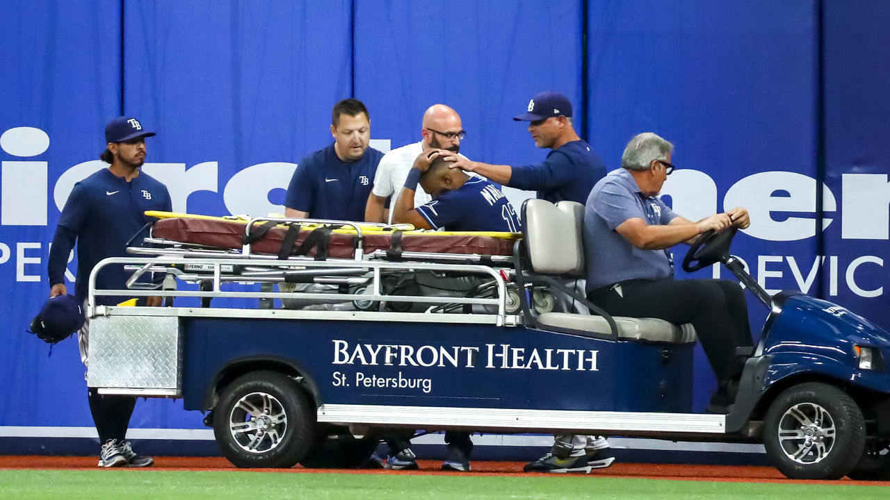 ST PETERSBURG, FL - JUNE 20: Manager Kevin Cash #16 of the Tampa Bay Rays pats Manuel Margot #13 as he is carted off the field due to injury in the ninth inning during the game against the New York Yankees at Tropicana Field on June 20, 2022 in St Petersburg, Florida.
