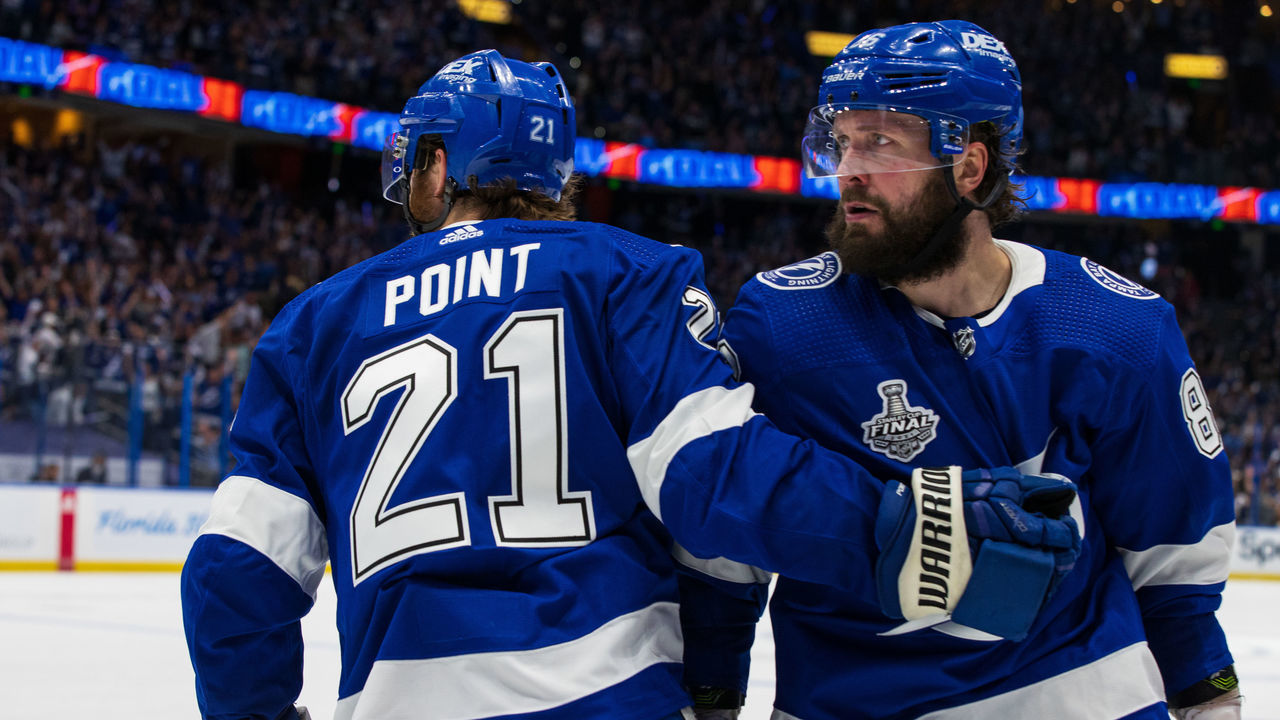 TAMPA, FL - JUNE 28: Nikita Kucherov #86 and Brayden Point #21 of the Tampa Bay Lightning celebrate a goal against the Montreal Canadiens during the third period in Game One of the Stanley Cup Final of the 2021 Stanley Cup Playoffs at Amalie Arena on June 25, 2021 in Tampa, Florida.