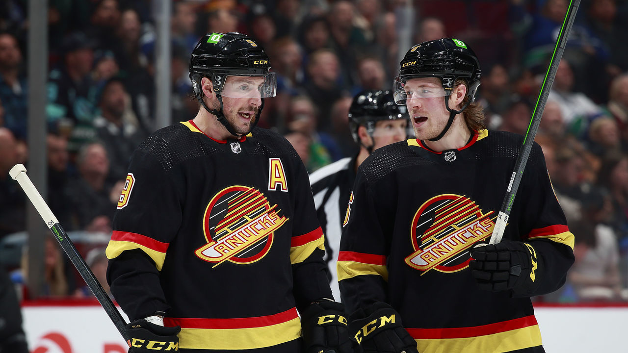VANCOUVER, BC - APRIL 26: J.T. Miller #9 and Brock Boeser #6 of the Vancouver Canucks talk during their NHL game against the Seattle Kraken at Rogers Arena April 26, 2022 in Vancouver, British Columbia, Canada. "n