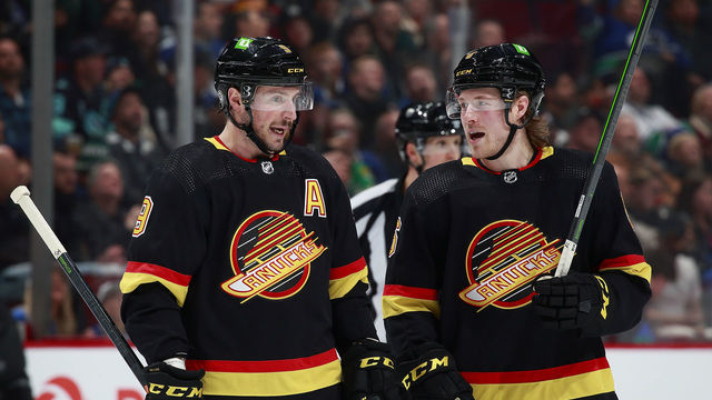 VANCOUVER, BC - APRIL 26: J.T. Miller #9 and Brock Boeser #6 of the Vancouver Canucks talk during their NHL game against the Seattle Kraken at Rogers Arena April 26, 2022 in Vancouver, British Columbia, Canada. "n