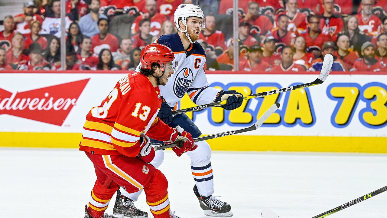 CALGARY, AB - MAY 18: Calgary Flames Left Wing Johnny Gaudreau (13) and Edmonton Oilers Center Connor McDavid (97) compete for position during the third period of game 1 of the second round of the NHL Stanley Cup Playoffs between the Calgary Flames and the Edmonton Oilers on May 18, 2022, at the Scotiabank Saddledome in Calgary, AB.
