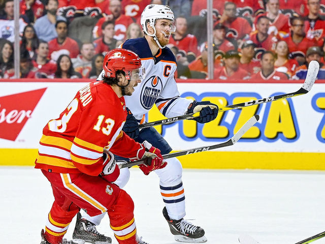 CALGARY, AB - MAY 18: Calgary Flames Left Wing Johnny Gaudreau (13) and Edmonton Oilers Center Connor McDavid (97) compete for position during the third period of game 1 of the second round of the NHL Stanley Cup Playoffs between the Calgary Flames and the Edmonton Oilers on May 18, 2022, at the Scotiabank Saddledome in Calgary, AB.