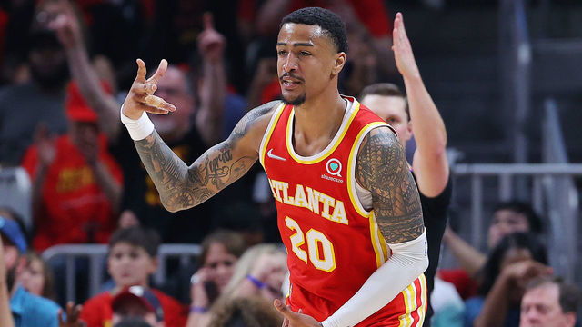 ATLANTA, GEORGIA - APRIL 22: John Collins #20 of the Atlanta Hawks celebrates a three pointer against the Miami Heat during the second quarter in Game Three of the Eastern Conference First Round at State Farm Arena on April 22, 2022 in Atlanta, Georgia.