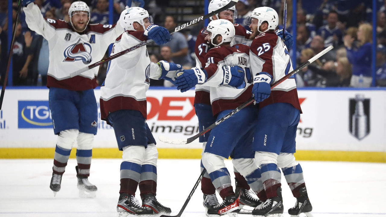 TAMPA, FLORIDA - JUNE 22: Gabriel Landeskog #92, Mikko Rantanen #96, J.T. Compher #37 and Logan O'Connor #25 of the Colorado Avalanche celebrate the game winning goal by Nazem Kadri #91 who scored in overtime to defeat the Tampa Bay Lightning 3-2 in Game Four of the 2022 NHL Stanley Cup Final at Amalie Arena on June 22, 2022 in Tampa, Florida.
