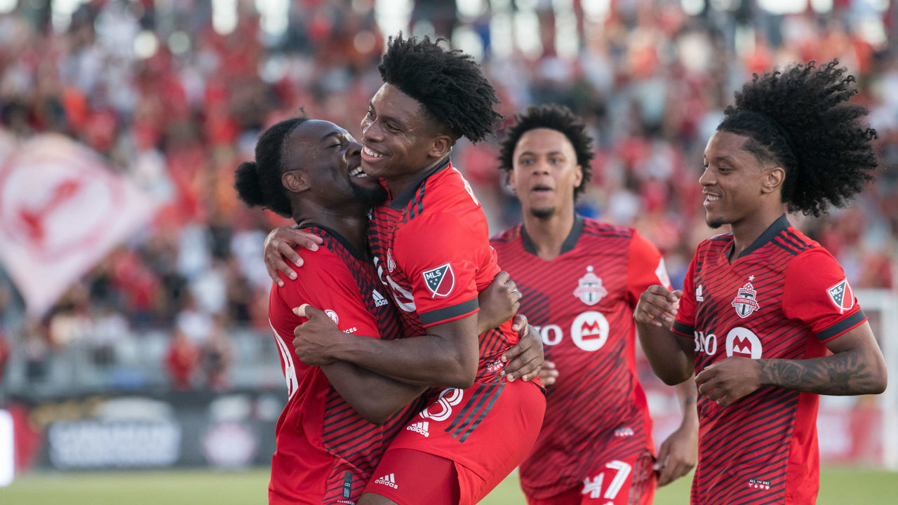 TORONTO, ONTARIO, CANADA - 2022/06/22: Kosi Thompson (R2), Jayden Nelson (R), Ralph Priso-Mbongue (L2) and Ayo Akinola (L) celebrates after Akinola scored a goal during the Canadian Championship game between Toronto FC and CF Montreal at BMO Field. The game ended 4-0 for Toronto FC.