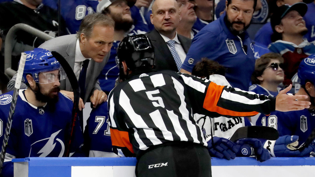 TAMPA, FLORIDA - JUNE 22: Head coach Jon Cooper of the Tampa Bay Lightning speaks to referee Chris Rooney #5 during the second period Game Three of the 2022 NHL Stanley Cup Final at Amalie Arena on June 22, 2022 in Tampa, Florida.
