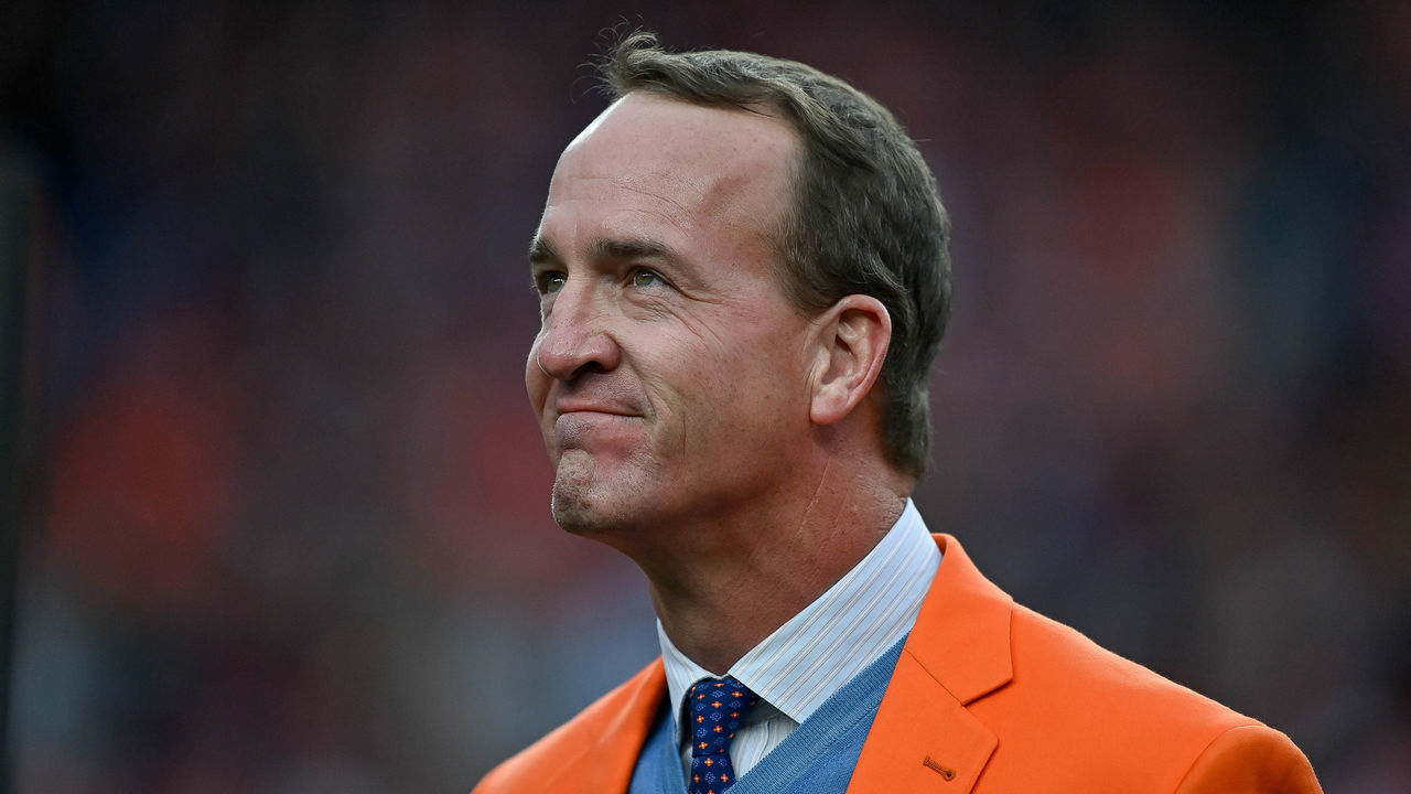 DENVER, CO - OCTOBER 31: Former Denver Broncos quarterback Peyton Manning looks on during a ceremony to reveal his name on the stadium Ring of Fame at halftime during a game between the Denver Broncos and the Washington Football Team at Empower Field at Mile High on October 31, 2021 in Denver, Colorado.