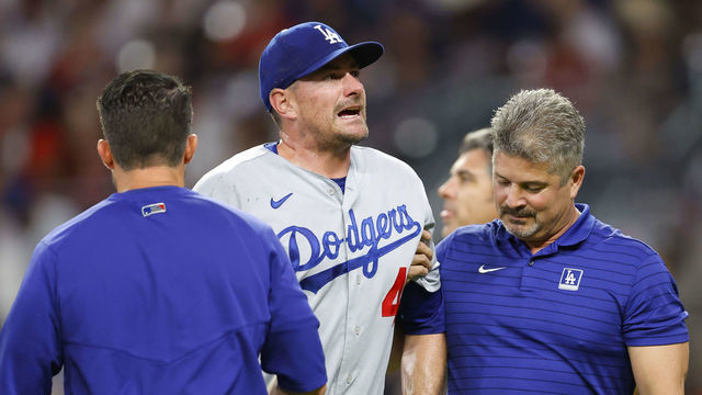 ATLANTA, GA - JUNE 24: Daniel Hudson #41 of the Los Angeles Dodgers is helped off the field after an injury during the eighth inning against the Atlanta Braves at Truist Park on June 24, 2022 in Atlanta, Georgia.