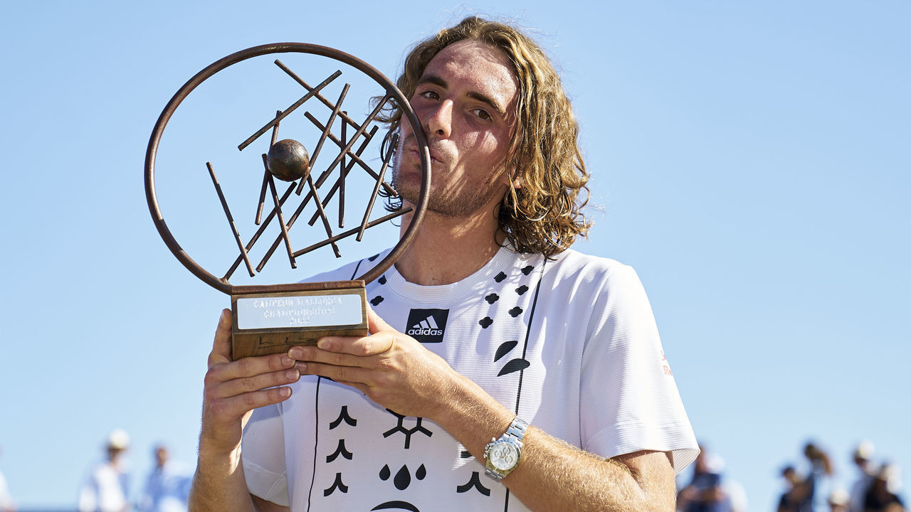 MALLORCA, SPAIN - JUNE 25: Stefanos Tsitsipas of Greece celebrates with the trophy after winning against Roberto Bautista of Spain in his Final match during day eighth of the Mallorca Championships at Mallorca Country Club on June 25, 2022 in Mallorca, Spain.