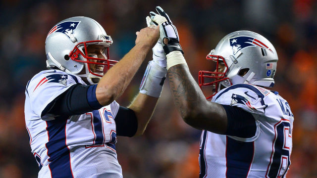 DENVER, CO - NOVEMBER 12: Quarterback Tom Brady #12 of the New England Patriots celebrates a fourth quarter touchdown against the Denver Broncos with offensive guard Shaq Mason #69 of the New England Patriots at Sports Authority Field at Mile High on November 12, 2017 in Denver, Colorado.
