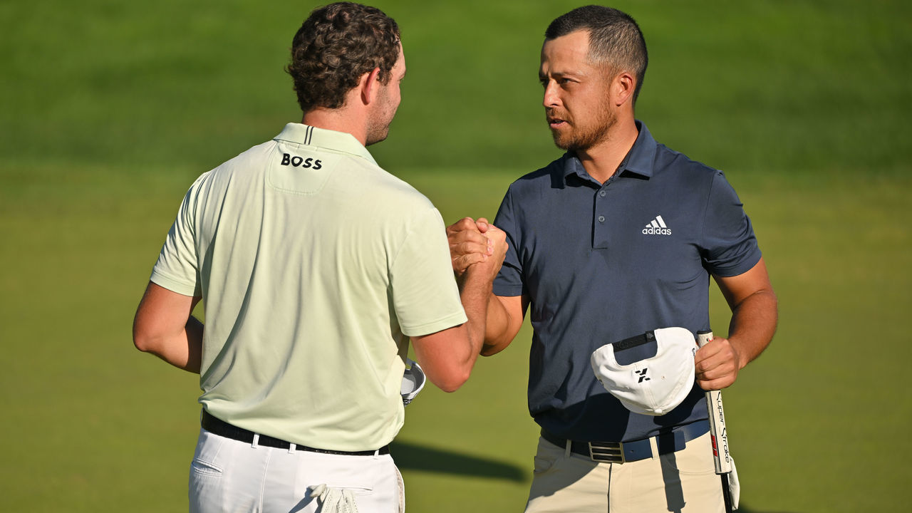 CROMWELL, CT - JUNE 25: Patrick Cantlay and Xander Schauffele shake hands on the 18th green during the third round of the Travelers Championship at TPC River Highlands on June 25, 2022 in Cromwell, Connecticut.