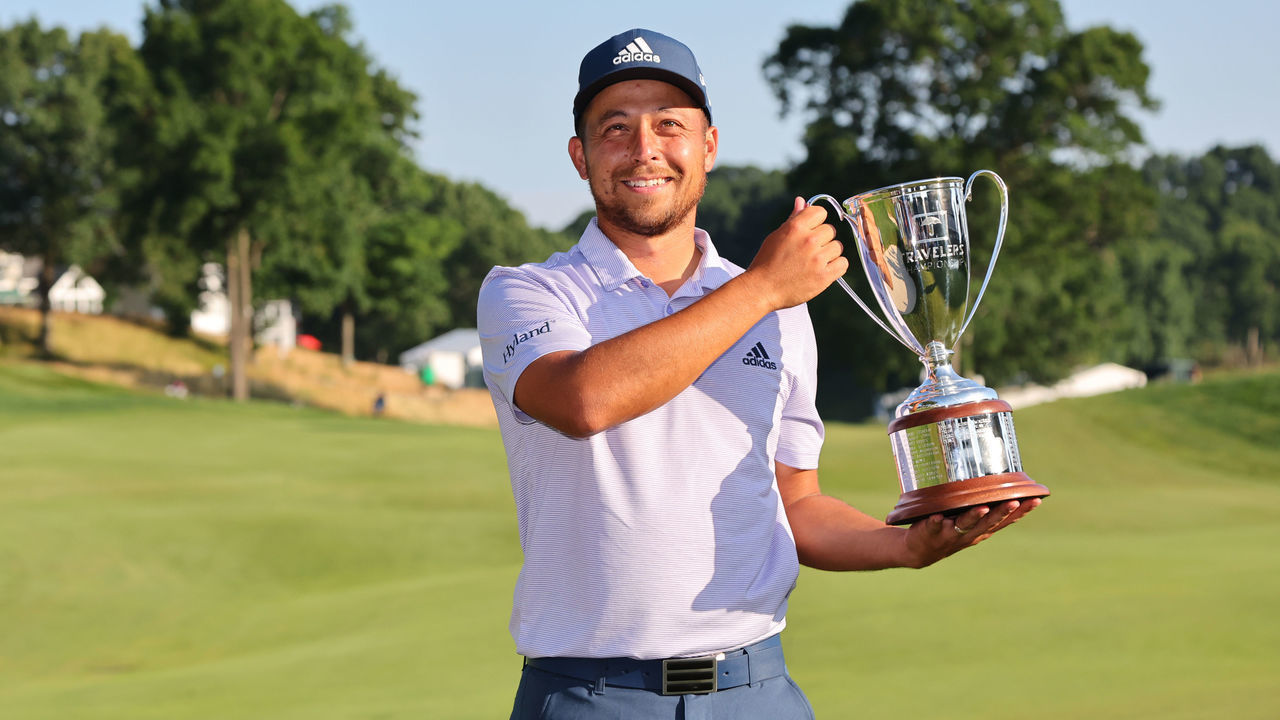 CROMWELL, CONNECTICUT - JUNE 26: Xander Schauffele of the United States poses with the trophy after putting in to win on the 18th green during the final round of Travelers Championship at TPC River Highlands on June 26, 2022 in Cromwell, Connecticut.