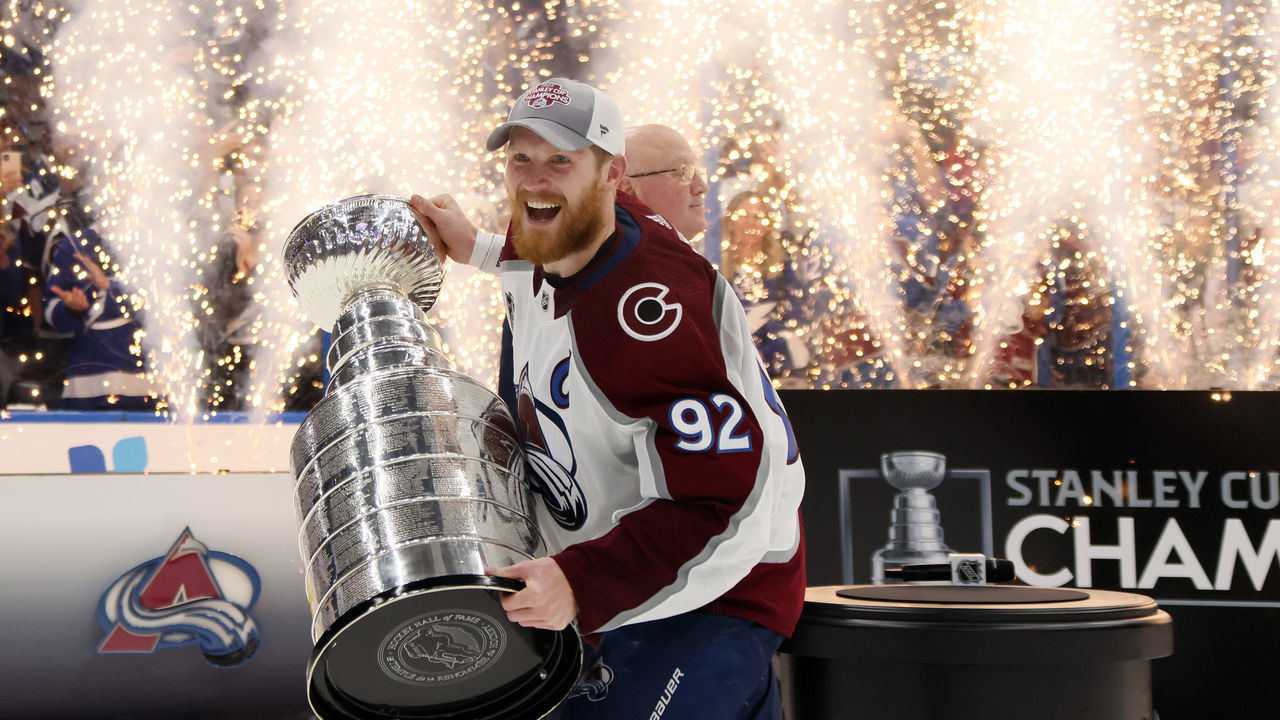 TAMPA, FLORIDA - JUNE 26: Gabriel Landeskog #92 of the Colorado Avalanche lifts the Stanley Cup after defeating the Tampa Bay Lightning 2-1 in Game Six of the 2022 NHL Stanley Cup Final at Amalie Arena on June 26, 2022 in Tampa, Florida.