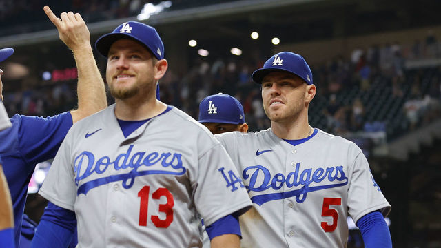 ATLANTA, GA - JUNE 26: Max Muncy #13 and Freddie Freeman #5 of the Los Angeles Dodgers celebrate after a 5-3 victory over the Atlanta Braves in 11 innings at Truist Park on June 26, 2022 in Atlanta, Georgia.
