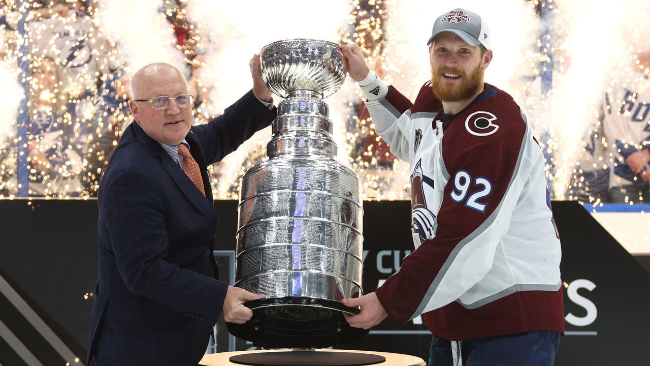 TAMPA, FLORIDA - JUNE 26: Deputy NHL Commissioner Bill Daly presents captain Gabriel Landeskog #92 of the Colorado Avalanche with the Stanley Cup after the Colorado Avalanche defeated the Tampa Bay Lightning in Game Six of the 2022 Stanley Cup Final at Amalie Arena on June 26, 2022 in Tampa, Florida. The Colorado Avalanche defeated the Tampa Bay Lightning 2-1 in Game Six to take the best of seven Stanley Cup Final series 4 games to 2.