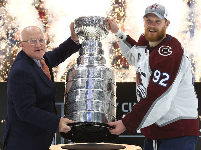 TAMPA, FLORIDA - JUNE 26: Deputy NHL Commissioner Bill Daly presents captain Gabriel Landeskog #92 of the Colorado Avalanche with the Stanley Cup after the Colorado Avalanche defeated the Tampa Bay Lightning in Game Six of the 2022 Stanley Cup Final at Amalie Arena on June 26, 2022 in Tampa, Florida. The Colorado Avalanche defeated the Tampa Bay Lightning 2-1 in Game Six to take the best of seven Stanley Cup Final series 4 games to 2.