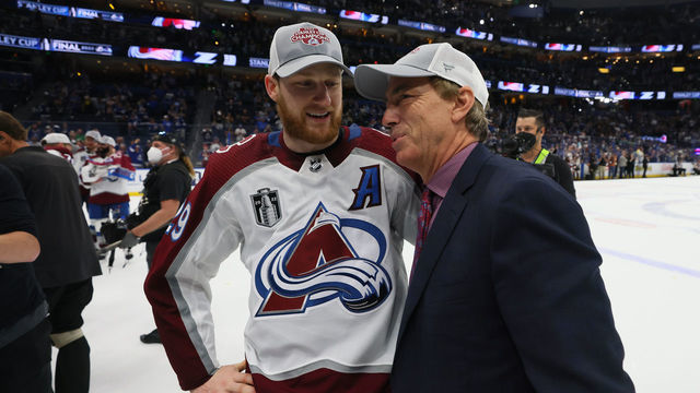 TAMPA, FLORIDA - JUNE 26: Nathan MacKinnon #29 of the Colorado Avalanche talks with General Manager Joe Sakic after defeating the Tampa Bay Lightning 2-1 in Game Six of the 2022 NHL Stanley Cup Final at Amalie Arena on June 26, 2022 in Tampa, Florida.