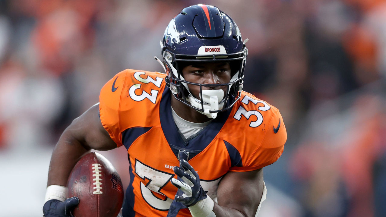 DENVER, COLORADO - DECEMBER 19: Javonte Williams #33 of the Denver Broncos carries the ball against the Cincinnati Bengals at Empower Field At Mile High on December 19, 2021 in Denver, Colorado.