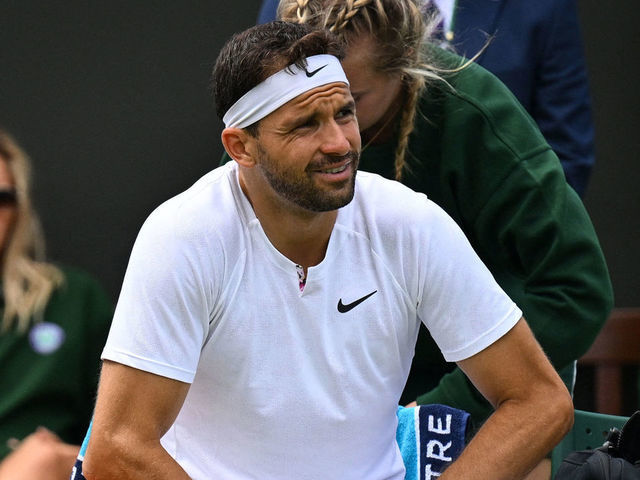 Bulgaria's Grigor Dimitrov sits on a chair as he reacts during his men's singles tennis match against US player Steve Johnson on the second day of the 2022 Wimbledon Championships at The All England Tennis Club in Wimbledon, southwest London, on June 28, 2022. - RESTRICTED TO EDITORIAL USE