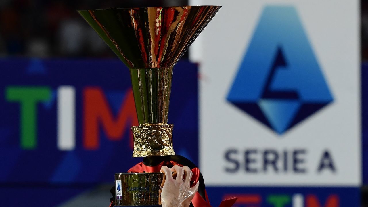 AC Milan's players celebrate with the winner's trophy after AC Milan won the Italian Serie A football match between Sassuolo and AC Milan, securing the "Scudetto" championship on May 22, 2022 at the Mapei - Citta del Tricolore stadium in Sassuolo.