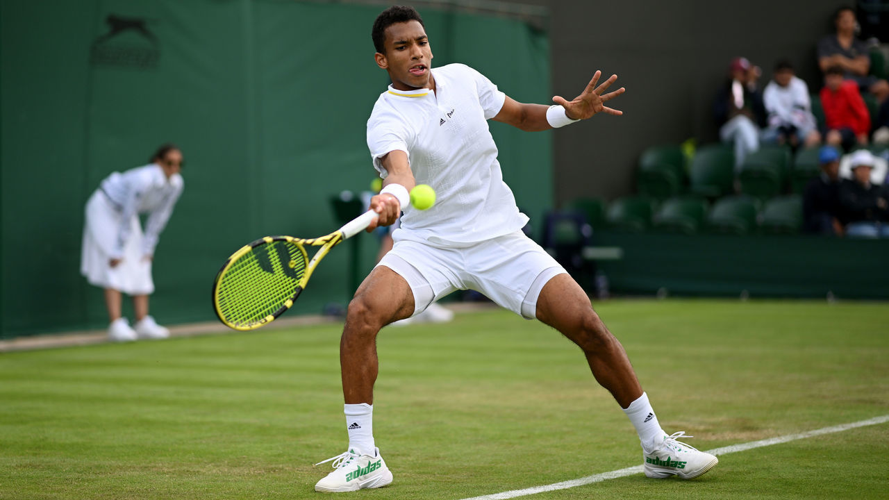 LONDON, ENGLAND - JUNE 28: Felix Auger-Aliassime of Canada plays a forehand against Maxime Cressy of United States of America during their Men's Singles First Round match on day two of The Championships Wimbledon 2022 at All England Lawn Tennis and Croquet Club on June 28, 2022 in London, England.