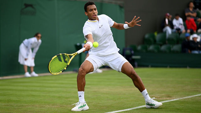 LONDON, ENGLAND - JUNE 28: Felix Auger-Aliassime of Canada plays a forehand against Maxime Cressy of United States of America during their Men's Singles First Round match on day two of The Championships Wimbledon 2022 at All England Lawn Tennis and Croquet Club on June 28, 2022 in London, England.