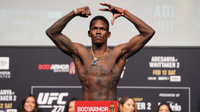 HOUSTON, TEXAS - FEBRUARY 11: Israel Adesanya of Nigeria poses on the scale during the UFC 271 ceremonial weigh-in at Toyota Center on February 11, 2022 in Houston, Texas.