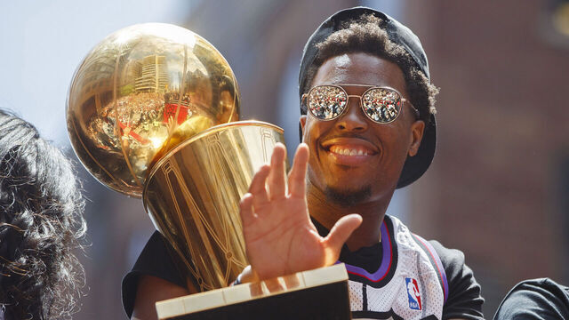 TORONTO, ON - JUNE 17: Kyle Lowry #7 of the Toronto Raptors holds the Larry O'Brien Championship Trophy on the team bus during the Toronto Raptors Championship Victory Parade on June 17, 2019 in Toronto, Ontario. NOTE TO USER: User expressly acknowledges and agrees that, by downloading and/or using this photograph, user is consenting to the terms and conditions of Getty Images License Agreement. Mandatory Copyright Notice: Copyright 2019 NBAE