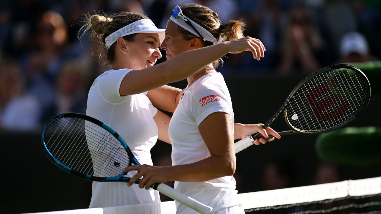 LONDON, ENGLAND - JUNE 30: Simona Halep of Romania and Kirsten Flipkens of Belgium embrace following their Women's Singles Second Round match on day four of The Championships Wimbledon 2022 at All England Lawn Tennis and Croquet Club on June 30, 2022 in London, England.
