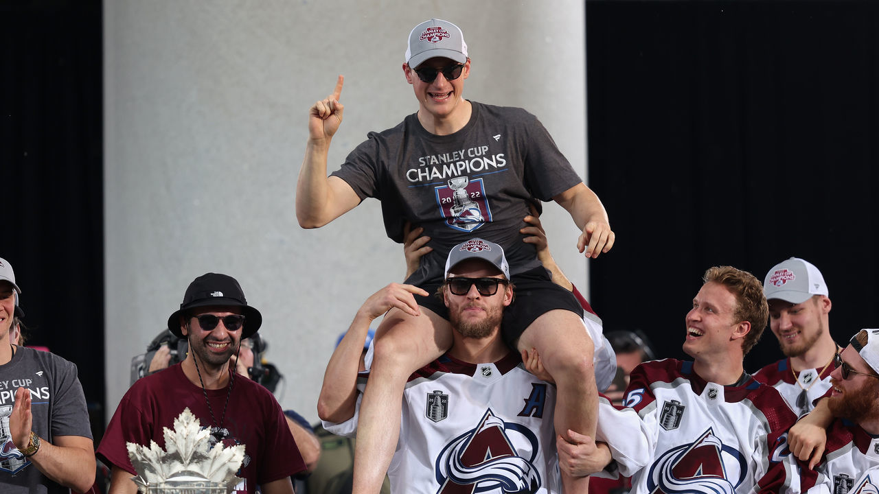 DENVER, COLORADO - JUNE 30: Cale Makar #8 of the Colorado Avalanche is lifted up by Mikko Rantanen #96 on-stage during the Colorado Avalanche Victory Parade and Rally at Civic Center Park on June 30, 2022 in Denver, Colorado.