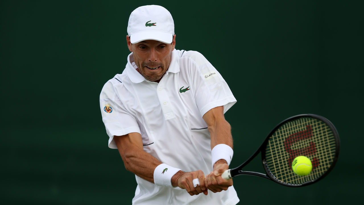 LONDON, ENGLAND - JUNE 28: Roberto Bautista Agut of Spain plays a backhand against Attila Balazs of Hungary during their Men's Singles First Round Match on day two of The Championships Wimbledon 2022 at All England Lawn Tennis and Croquet Club on June 28, 2022 in London, England.