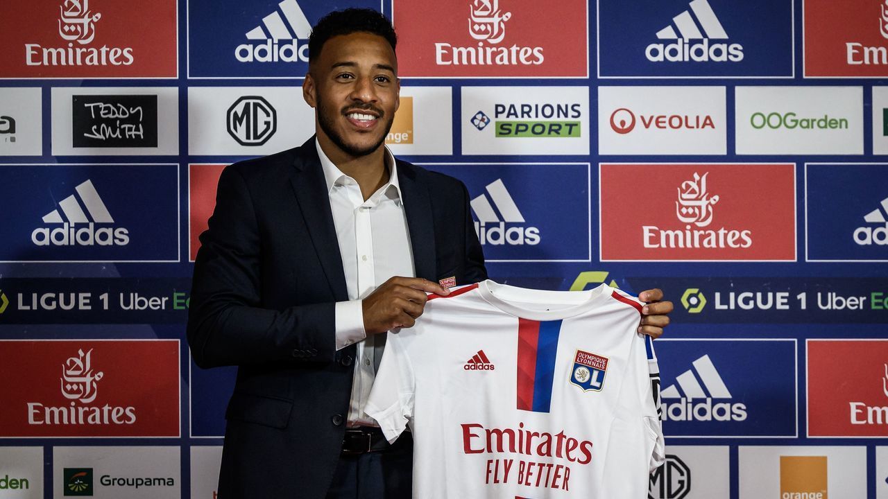 French midfielder Corentin Tolisso poses with his jersey during a press conference to announce his return to Ligue 1 Olympique Lyonnais (OL) football club in Decines-Charpieu near Lyon centraleastern of France on July 1, 2022.