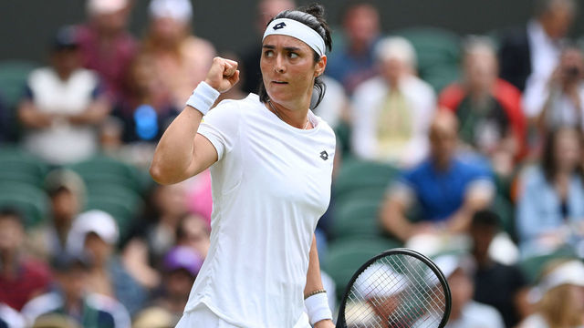 Tunisia's Ons Jabeur reacts as she competes against France's Diane Parry during their women's singles tennis match on the fifth day of the 2022 Wimbledon Championships at The All England Tennis Club in Wimbledon, southwest London, on July 1, 2022. - RESTRICTED TO EDITORIAL USE