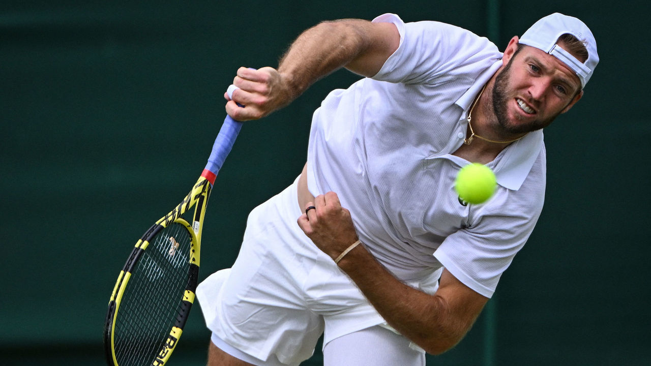 US player Jack Sock serves the ball to US player Maxime Cressy during their men's singles tennis match on the fifth day of the 2022 Wimbledon Championships at The All England Tennis Club in Wimbledon, southwest London, on July 1, 2022. - RESTRICTED TO EDITORIAL USE