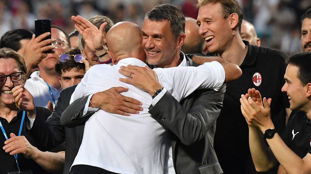 AC Milan's Italian head coach Stefano Pioli (L) embraces AC Milan's former player turned technical director, Paolo Maldini during the winner's trophy ceremony after AC Milan won the Italian Serie A football match between Sassuolo and AC Milan, securing the "Scudetto" championship on May 22, 2022 at the Mapei - Citta del Tricolore stadium in Sassuolo.