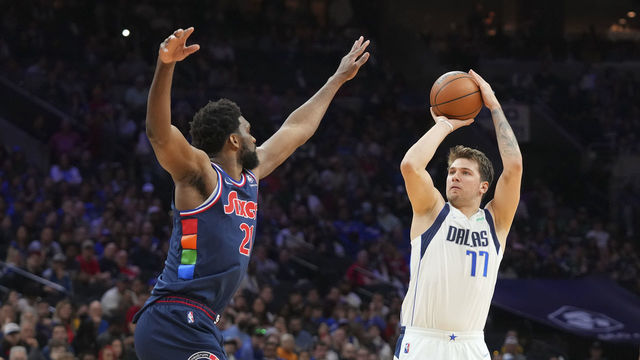 PHILADELPHIA, PA - MARCH 18: Luka Doncic #77 of the Dallas Mavericks shoots the ball against Joel Embiid #21 of the Philadelphia 76ers at the Wells Fargo Center on March 18, 2022 in Philadelphia, Pennsylvania. The 76ers defeated the Mavericks 111-101.