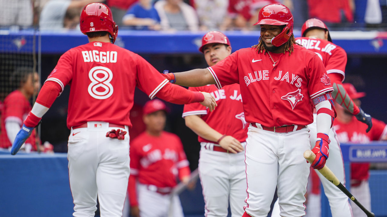 TORONTO, ON - JULY 1: Cavan Biggio #8 of the Toronto Blue Jays celebrates scoring with Vladimir Guerrero Jr. #27 against the Tampa Bay Rays in the third inning during their MLB game at the Rogers Centre on July 1, 2022 in Toronto, Ontario, Canada.