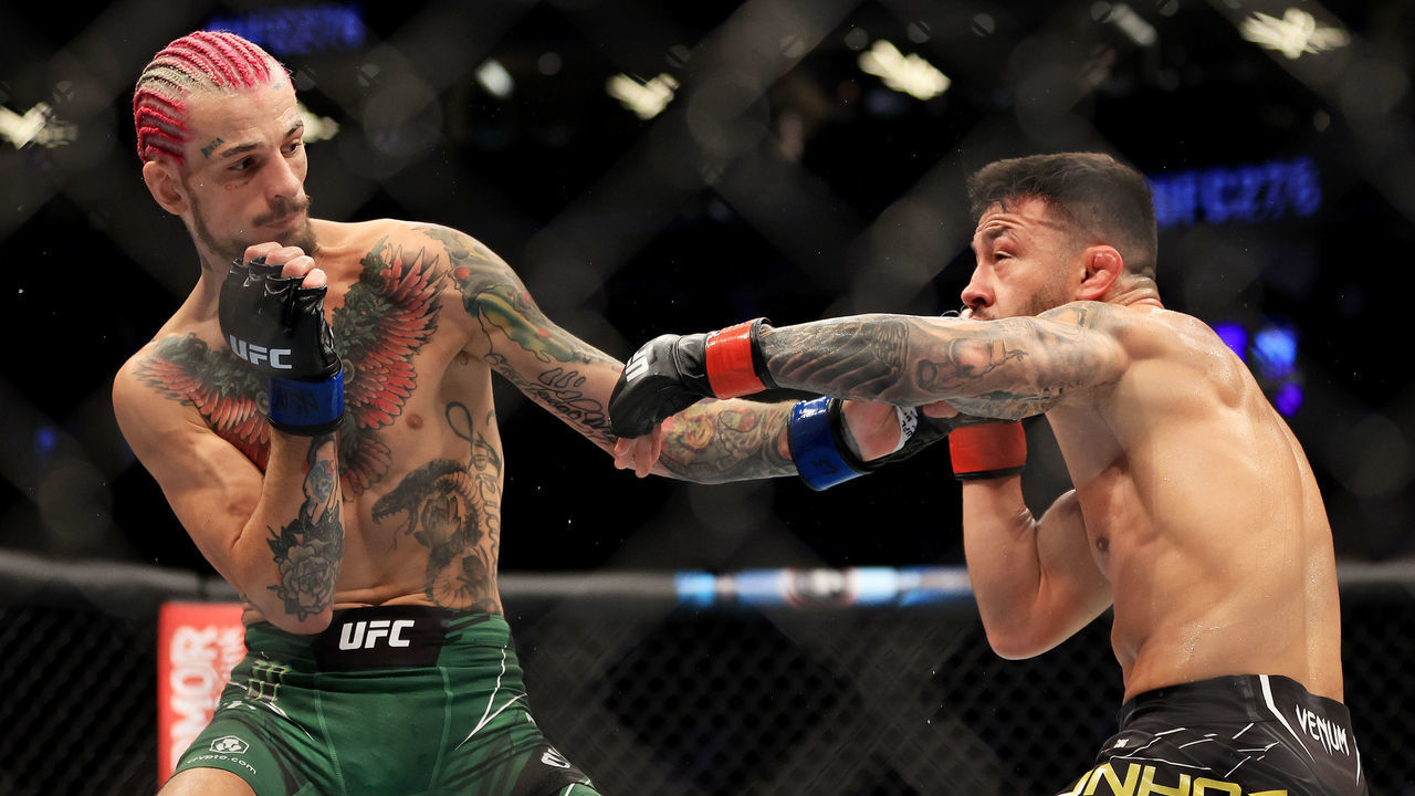 LAS VEGAS, NEVADA - JULY 02: Pedro Munhoz (R) of Brazil exchanges strikes with Sean O'Malley in their bantamweight bout during UFC 276 at T-Mobile Arena on July 02, 2022 in Las Vegas, Nevada.