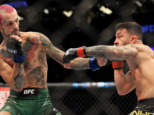 LAS VEGAS, NEVADA - JULY 02: Pedro Munhoz (R) of Brazil exchanges strikes with Sean O'Malley in their bantamweight bout during UFC 276 at T-Mobile Arena on July 02, 2022 in Las Vegas, Nevada.