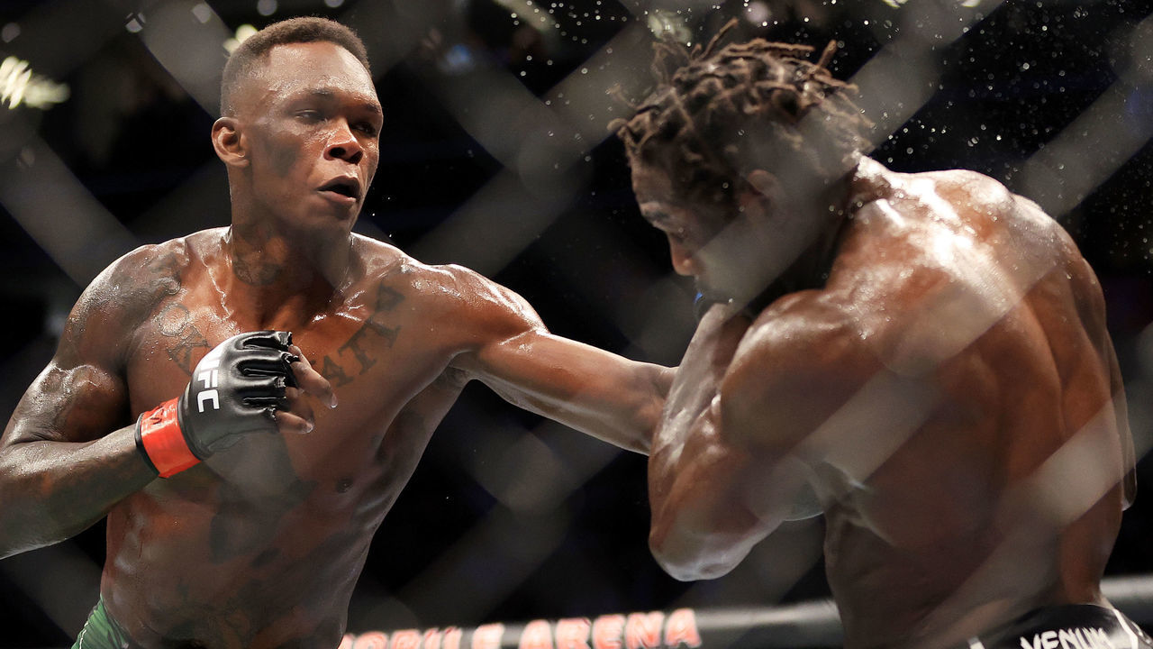 LAS VEGAS, NEVADA - JULY 02: Israel Adesanya (L) of Nigeria punches Jared Cannonier in their middleweight title bout during UFC 276 at T-Mobile Arena on July 02, 2022 in Las Vegas, Nevada.