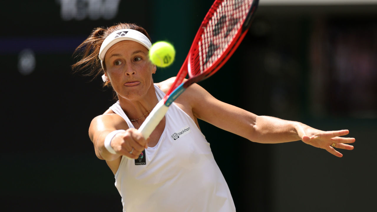 LONDON, ENGLAND - JULY 03: Tatjana Maria of Germany plays a backhand against Jelena Ostapenko of Latvia during their Women's Singles Fourth Round match on day seven of The Championships Wimbledon 2022 at All England Lawn Tennis and Croquet Club on July 03, 2022 in London, England.
