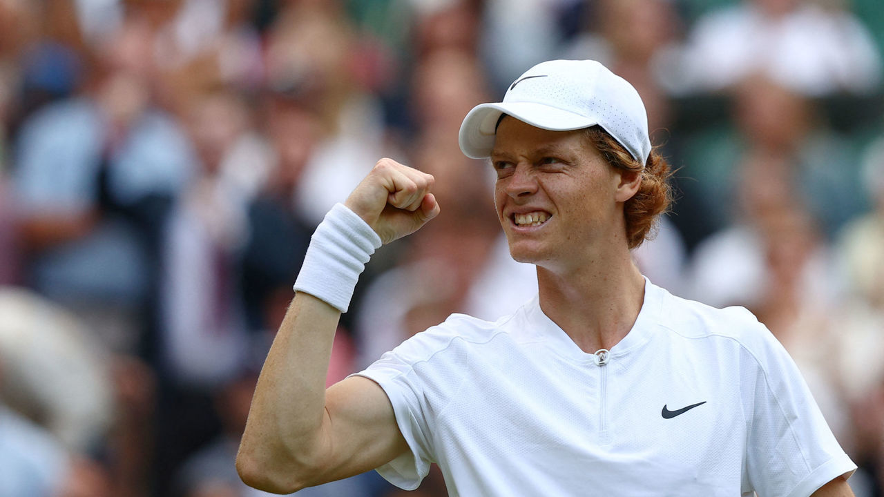 Italy's Jannik Sinner reacts as he competes against Spain's Carlos Alcaraz during their round of 16 men's singles tennis match on the seventh day of the 2022 Wimbledon Championships at The All England Tennis Club in Wimbledon, southwest London, on July 3, 2022. - RESTRICTED TO EDITORIAL USE