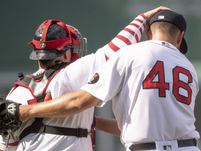 BOSTON, MA - JULY 4: John Schreiber #46 of the Boston Red Sox reacts with Christian Vázquez #7 of the Boston Red Sox after a win against the Tampa Bay Rays on July 4, 2022 at Fenway Park in Boston, Massachusetts.